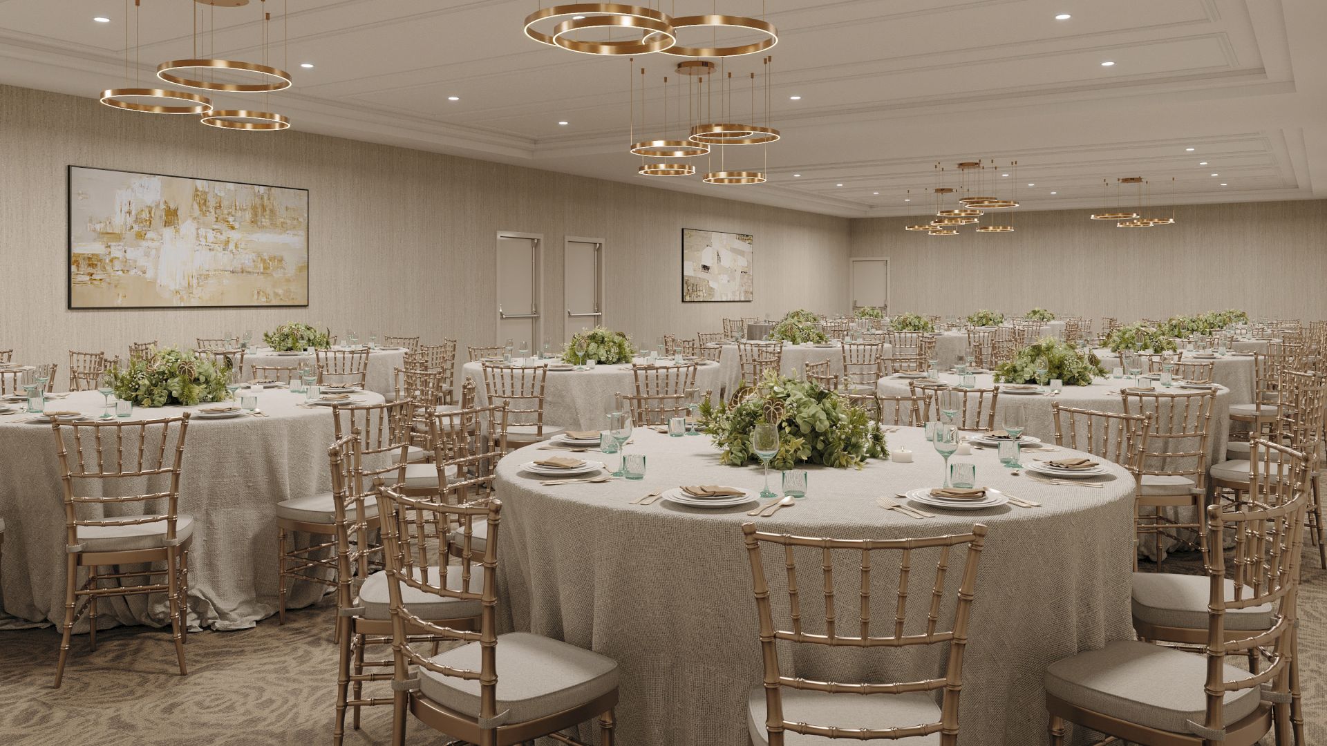 An elegant banquet hall with round tables, gold chiavari chairs, floral centerpieces, and multiple gold ring chandeliers overhead.