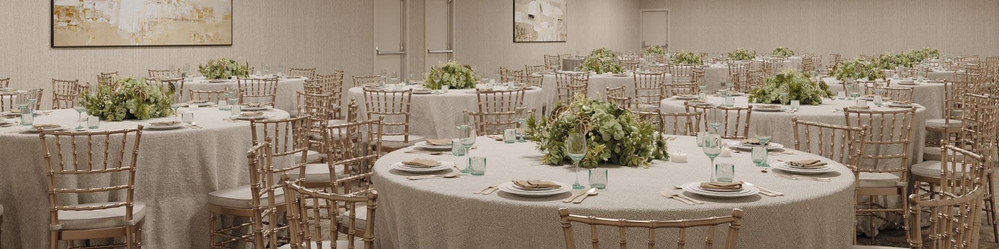 An elegant banquet hall with round tables, gold chiavari chairs, floral centerpieces, and multiple gold ring chandeliers overhead.