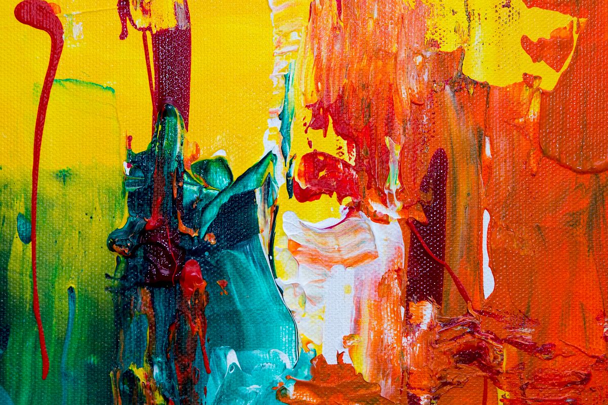 This image is a colorful abstract painting featuring vibrant hues of yellow, red, orange, green, and blue with dynamic brushstrokes and drips creating texture.