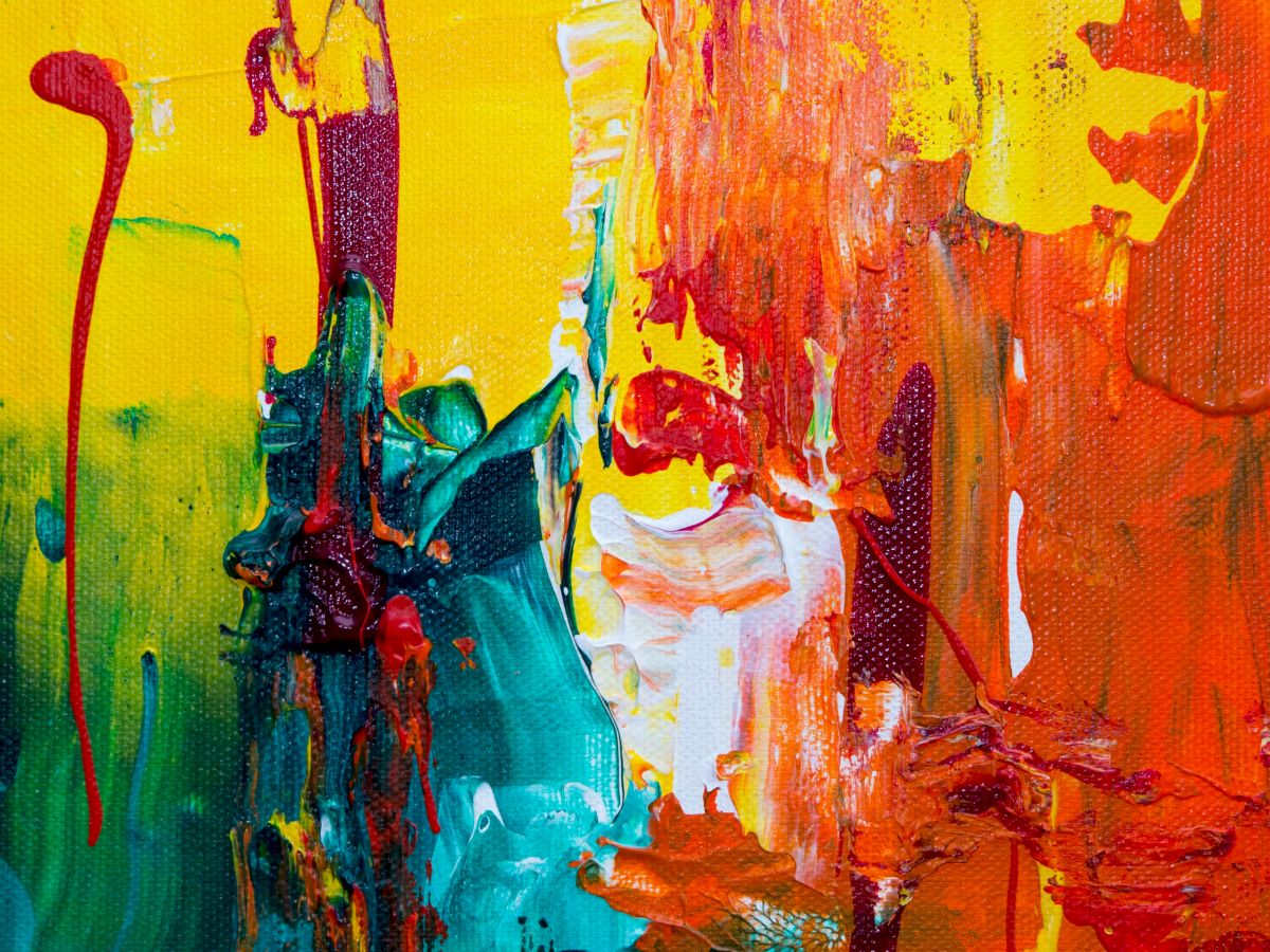 This image is a colorful abstract painting featuring vibrant hues of yellow, red, orange, green, and blue with dynamic brushstrokes and drips creating texture.